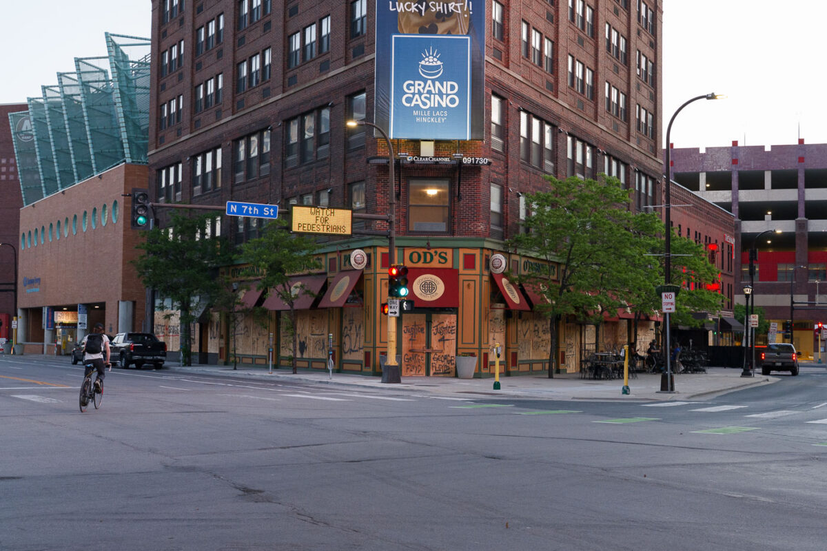 A biker bikes down N 7th St on May 28, 2020  in front of a boarded up O'Donovan's Irish Pub in Downtown Minneapolis on the 3rd day of protests in Minneapolis following the death of George Floyd.