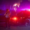 A Minneapolis Police officer outside of the burning AutoZone during the 2nd day of protests in Minneapolis following the death of George Floyd.