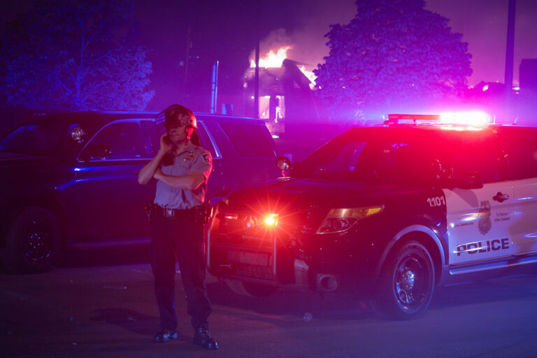 Minneapolis Police Officer during Minneapolis riots 2 A Minneapolis Police officer outside of the burning AutoZone during the 2nd day of protests in Minneapolis following the death of George Floyd.