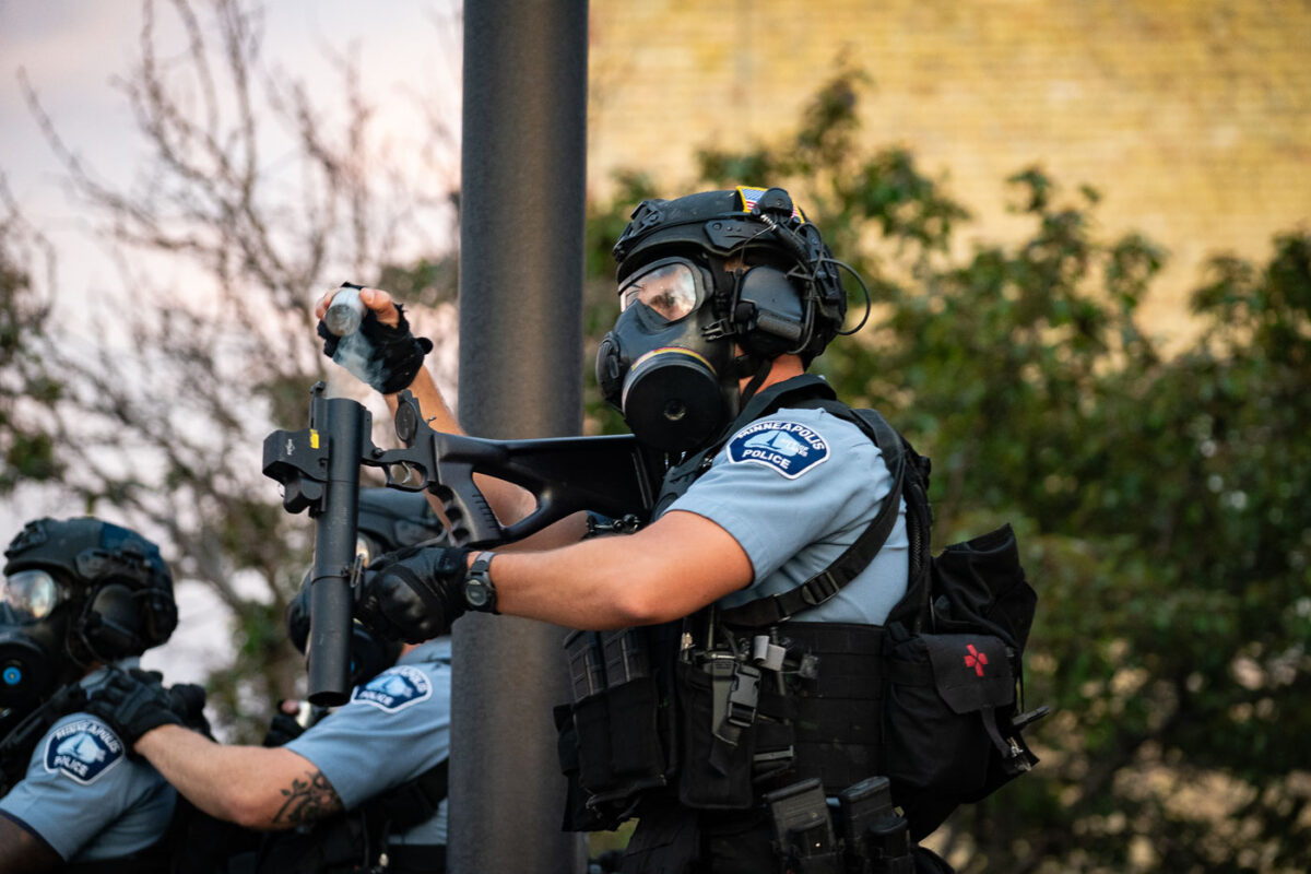 A Minneapolis Police officer re-loading his “less lethal” weapon outside the 3rd Precinct where protesters are gathered on the 2nd day of protests following the death of George Floyd.