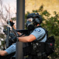 A Minneapolis Police officer re-loading his “less lethal” weapon outside the 3rd Precinct where protesters are gathered on the 2nd day of protests following the death of George Floyd.