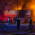 Minneapolis Police outside the burning AutoZone store on the 2nd day of protests in Minneapolis following the death of George Floyd.