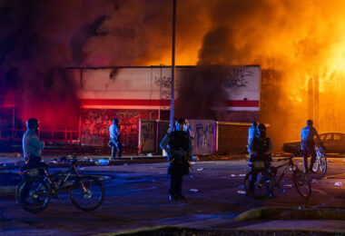 Minneapolis Police outside the burning AutoZone store on the 2nd day of protests in Minneapolis following the death of George Floyd.