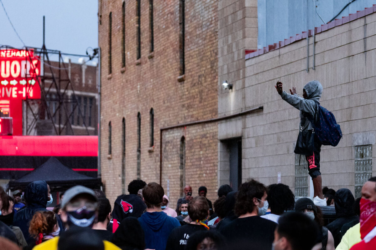 A protester stands on top of a Minneapolis Police squad car outside the 3rd Precinct. The large crowd marched from 38th Street and Chicago Ave the day after George Floyd was killed.