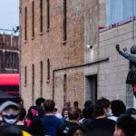 A protester stands on top of a Minneapolis Police squad car outside the 3rd Precinct. The large crowd marched from 38th Street and Chicago Ave the day after George Floyd was killed.