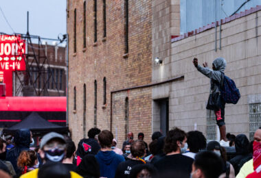 A protester stands on top of a Minneapolis Police squad car outside the 3rd Precinct. The large crowd marched from 38th Street and Chicago Ave the day after George Floyd was killed.