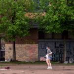 A woman holding jugs of milk outside the Minneapolis Police 3rd Precinct during protests the day after George Floyd was killed.