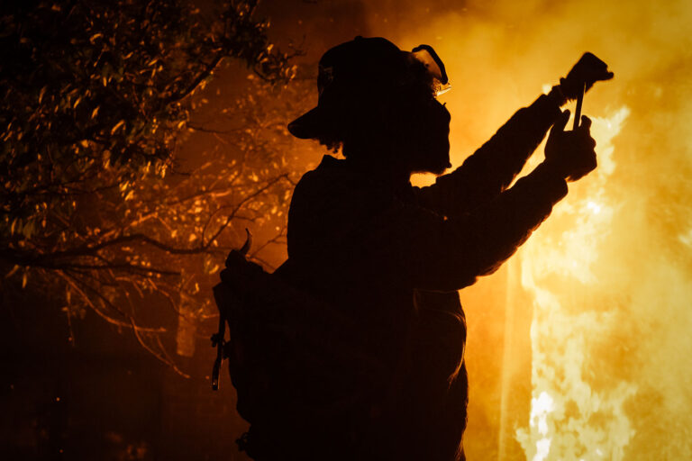 Protester holds up his first 1 A protester holds up his first as the Minneapolis Police 3rd Precinct burns in the background. This was on the 3rd day of protests in Minneapolis following the death of George Floyd.