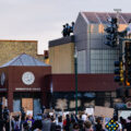 Protesters outside the battered 3rd precinct police station as officers surround it. This follows the death of George Floyd on May 25th, 2020. The precinct would be abandoned and burned the next evening.