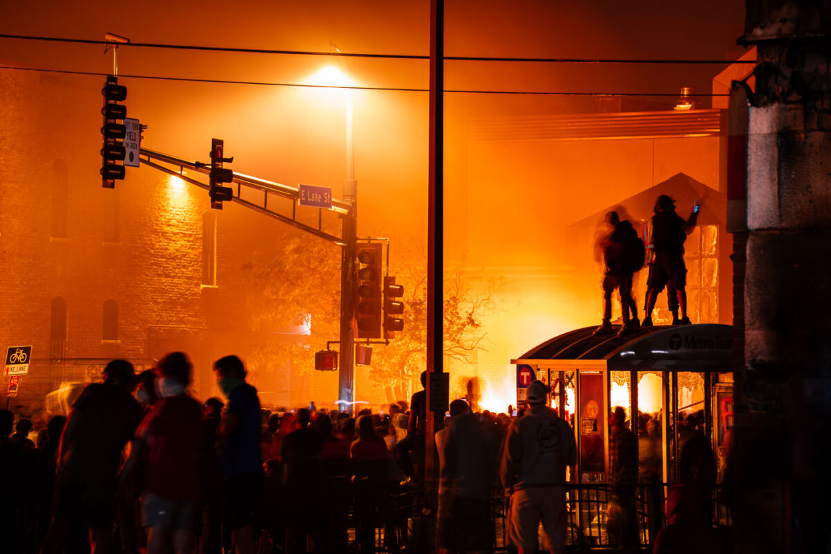 Protesters outside the burning Minneapolis Police 3rd Precinct. The precinct was lit on fire after being overrun by protesters on the 3rd day of protests in Minneapolis following the death of George Floyd.