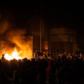 Protesters around the burning Minneapolis Police third precinct on the evening of May 28th, 2020. Protesters began gathering around the precinct days earlier following the death of George Floyd. Hours earlier,  Minneapolis Police vacated the precinct. The third precinct was the home precinct to Derek Chauvin who was ultimately convicted in the murder.