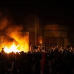 Protesters around the burning Minneapolis Police third precinct on the evening of May 28th, 2020. Protesters began gathering around the precinct days earlier following the death of George Floyd. Hours earlier,  Minneapolis Police vacated the precinct. The third precinct was the home precinct to Derek Chauvin who was ultimately convicted in the murder.