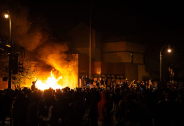 Protesters around the burning Minneapolis Police third precinct on the evening of May 28th, 2020. Protesters began gathering around the precinct days earlier following the death of George Floyd. Hours earlier,  Minneapolis Police vacated the precinct. The third precinct was the home precinct to Derek Chauvin who was ultimately convicted in the murder.