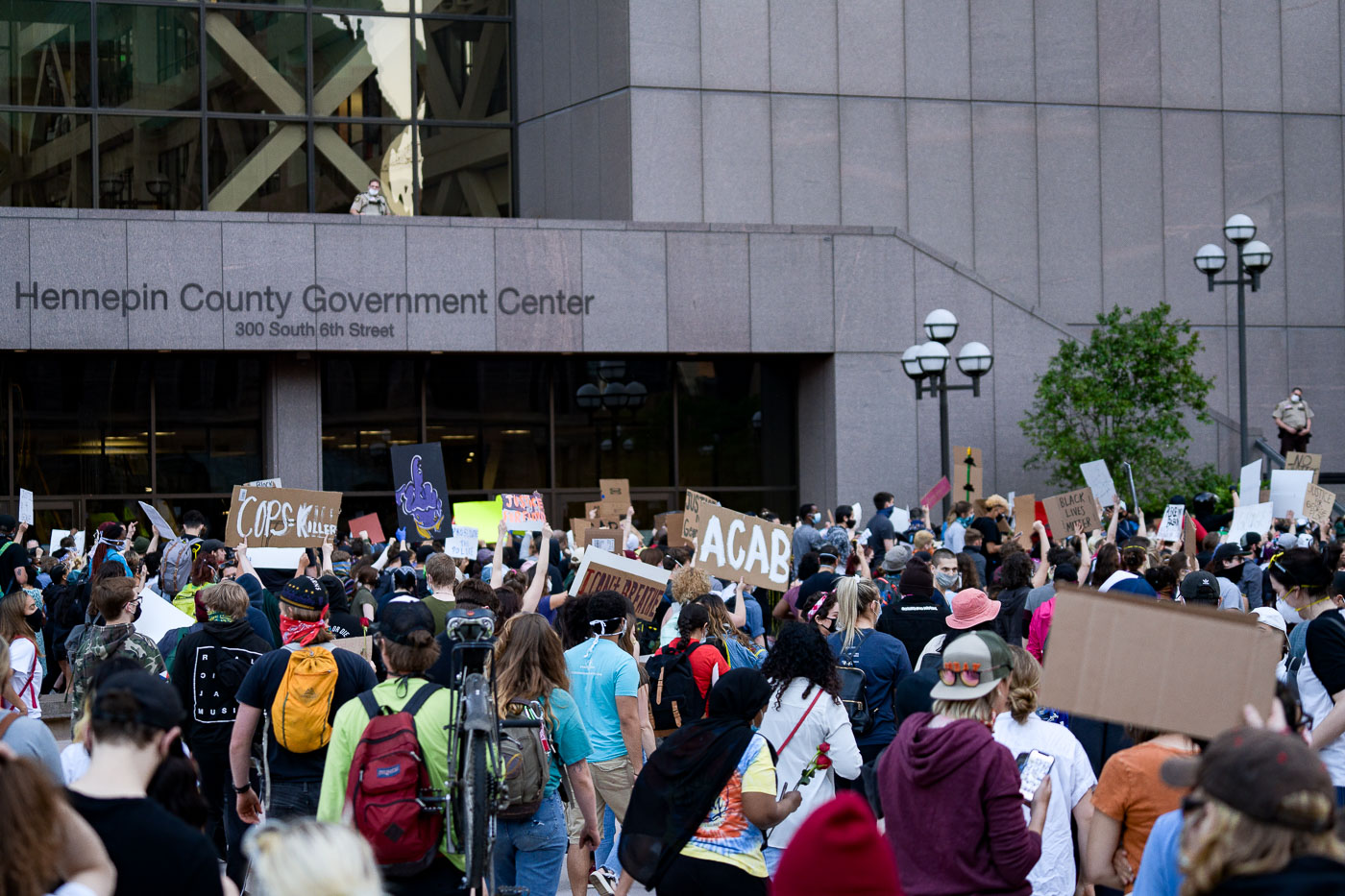 Protesters with signs in front of Hennepin County Government Center