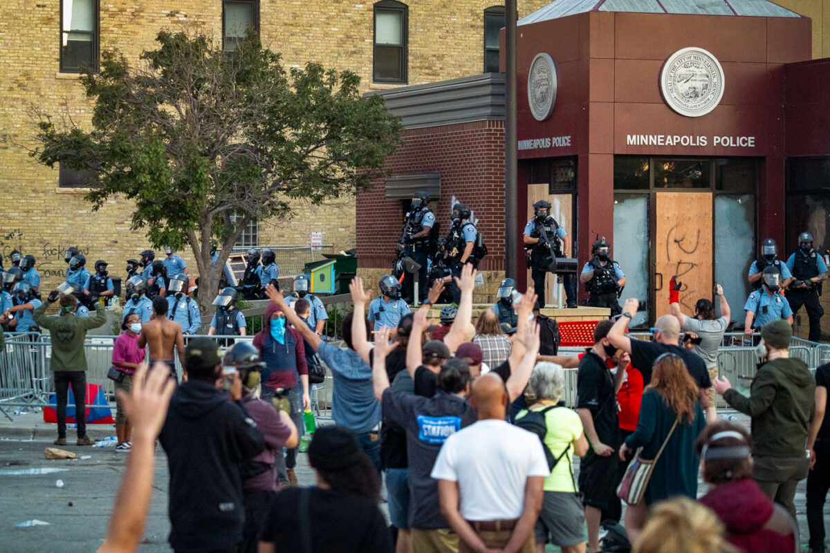 Protestors chanting "hands up don't shoot!" and "George Floyd!" outside the Minneapolis police third precinct.