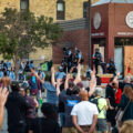 Protestors chanting "hands up don't shoot!" and "George Floyd!" outside the Minneapolis police third precinct.