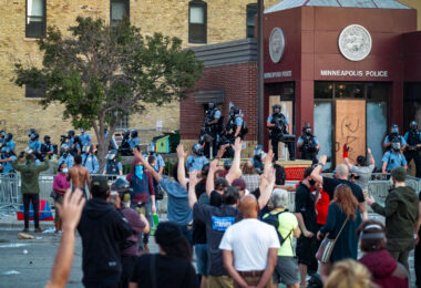 Protesters chanting "hands up don't shoot!" and "George Floyd!" outside the Minneapolis police third precinct.