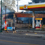 A car drives by a Shell gas station on Lake Street in Minneapolis on the morning of May 30, 2020 after nights of fires in Minneapolis.