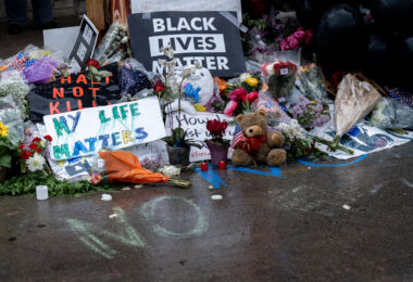 Flowers, signs and bears left behind on May 26, 2020 at a memorial where George Floyd was killed the night before.
