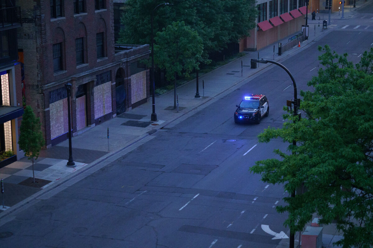 A Minneapolis Police squad car in front of S 10th St boarded up businesses on the 4th day of protests in Minneapolis following the death of George Floyd.