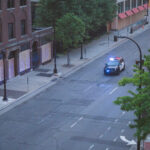 A Minneapolis Police squad car in front of S 10th St boarded up businesses on the 4th day of protests in Minneapolis following the death of George Floyd.