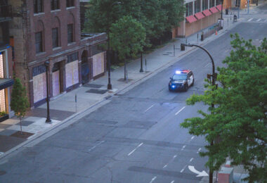 A Minneapolis Police squad car in front of S 10th St boarded up businesses on the 4th day of protests in Minneapolis following the death of George Floyd.