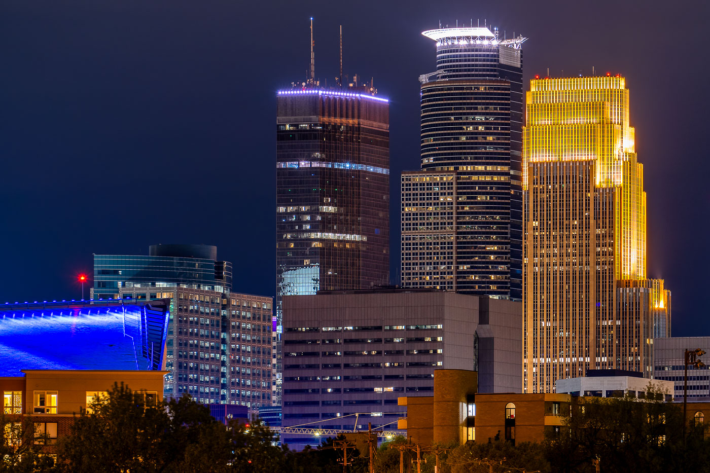 The Capella Tower, IDS Center, and Wells Fargo Center in Downtown Minneapolis at night.