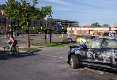 A smashed up car outside of the looted US Bank building on Lake Street.
