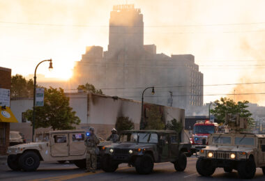 The Minnesota National Guard guards the Minneapolis Fire Department as they work to put out fires following nights of protests in Minneapolis following the death of George Floyd.