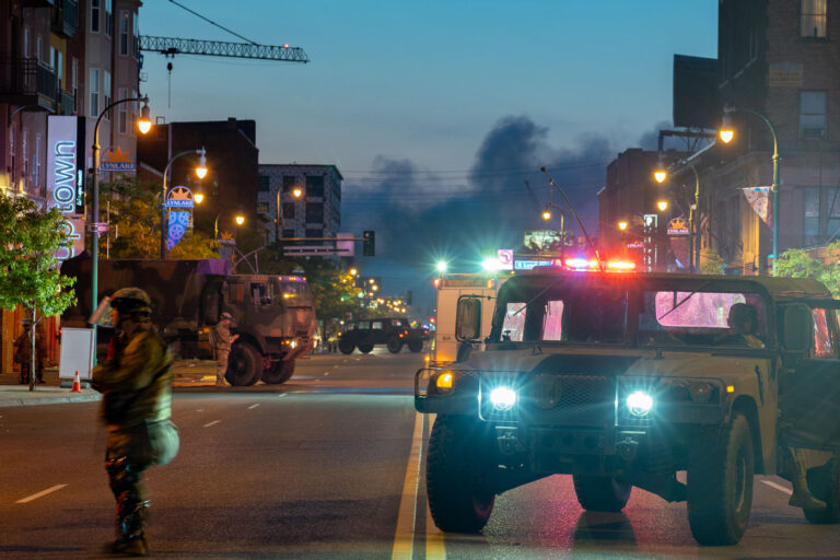 The sun rises with smoke in the air 3 The Minnesota National Guard on Lake Street in Uptown Minneapolis on May 30, 2020 after nights of riots and burning buildings.