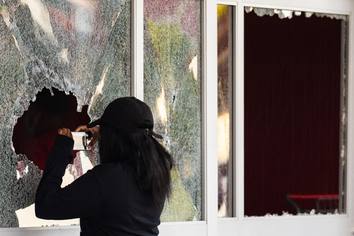 Someone takes a photo through the broken windows of the Target Store on East Lake Street.