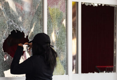 Someone takes a photo through the broken windows of the Target Store on East Lake Street.