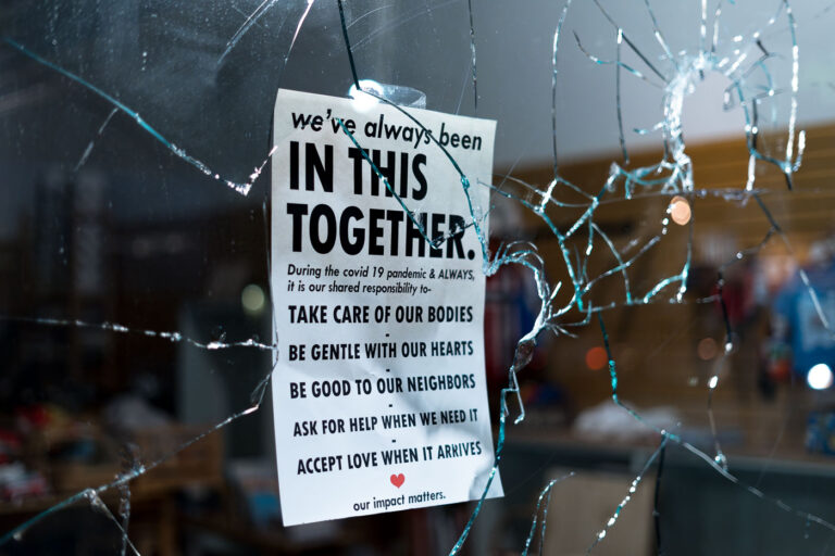 We've always been in this together 3 Broken storefront window during the riots on the 2nd day of protests in Minneapolis following the death of George Floyd. Sign hanging in the window reading "We've always been in this together. During the covid 19 pandemic & ALWAYS, it is our shared responsibility to- Take care of our bodies. Be gentle with our hearts. Be good to our neighbors. Ask for help when we need it. Accept love when it arrives. Our impact matters.