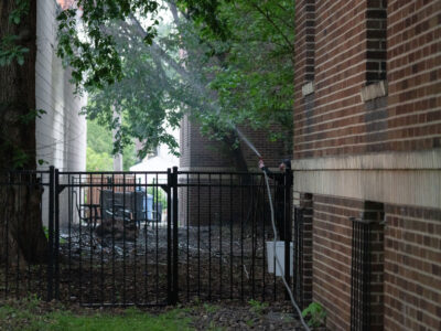 Resident Hoses O'Reilly Fire, Nicollet Ave