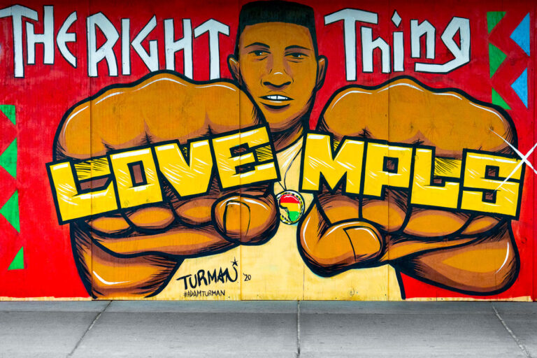 Adam Turman George Floyd Mural 2 Mural located on Hennepin Avenue in Uptown Minneapolis by Adam Turman. The boards on Uptown Theatre read “Do the right thing” “Love MPLS” “Justice for George Floyd”.