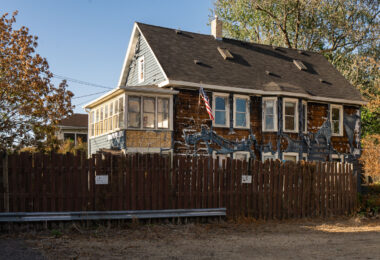 Siding burned off a building in South Minneapolis with an American Flag hanging from it. The heat from nearby fires burned the siding off.