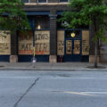 "Peoples Pets Live Here", "Kids Live Here", "Black Lives Matter" and "Justice 4 George" written on boards in downtown Minneapolis on 06/04/20.