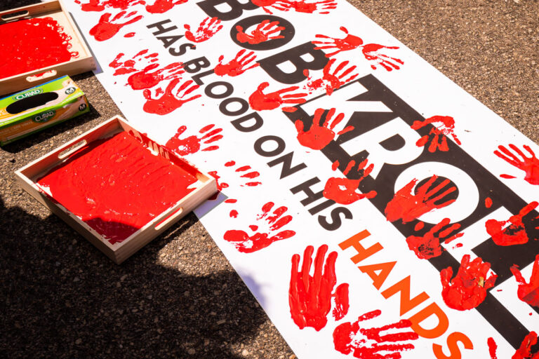 Bob Kroll has blood on his hands 1 Protesters dip their hands in red paint to leave hand prints on a protest banner that reads “Bob Kroll has blood on his hands”. The protest outside of the Minneapolis police union headquarters where Bob Kroll was the union head for many years.