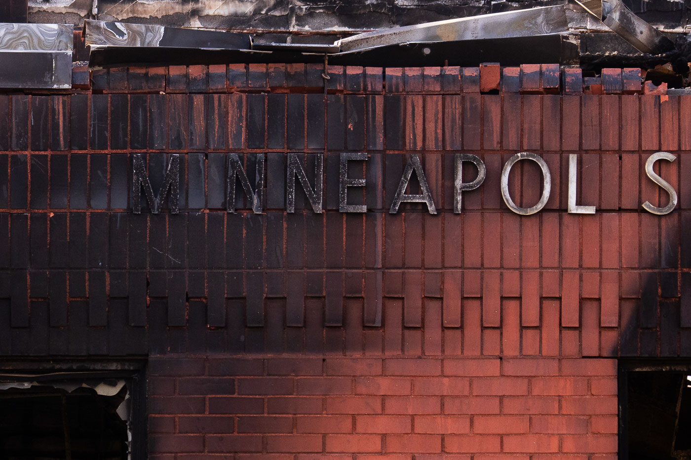 Burned letters on the side of a post office after a fire