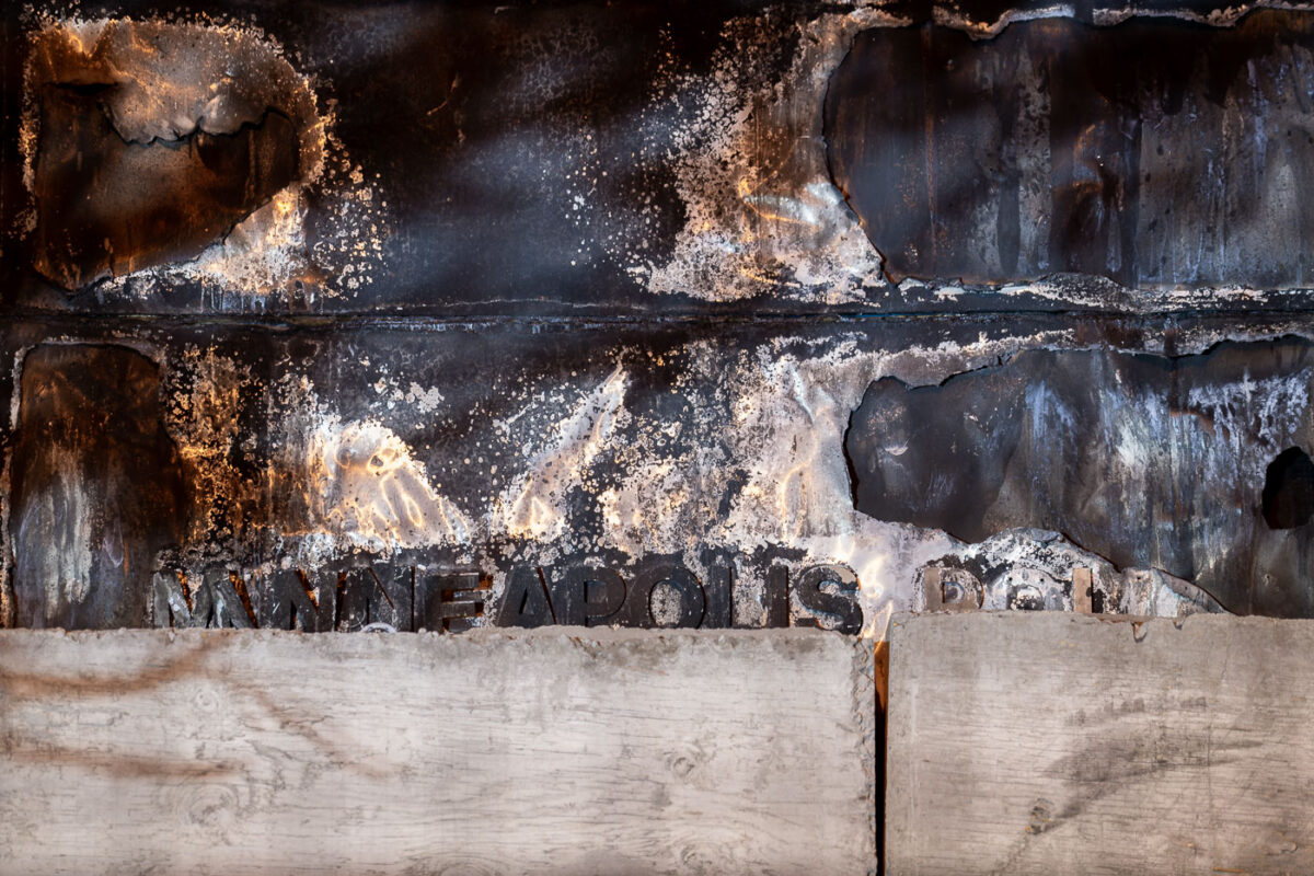 The remaining letters burned on the front of the Minneapolis Third Precinct. The precinct was burned during unrest over the killing of George Floyd.