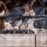 The remaining letters burned on the front of the Minneapolis Third Precinct. The precinct was burned during unrest over the killing of George Floyd.