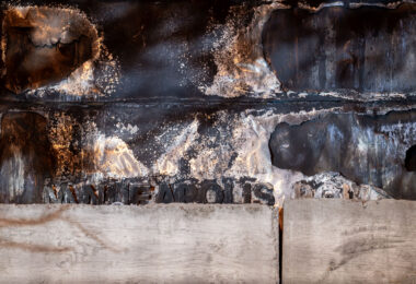 The remaining letters burned on the front of the Minneapolis Third Precinct. The precinct was burned during unrest over the killing of George Floyd.