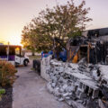 A bus stops outside the former Atlus Staffing building on East Lake Street. The building was burned following the death of George Floyd.