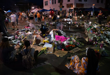 Flowers and signs left behind at a memorial in middle of 38th St and Chicago Ave on 06/04/20.
