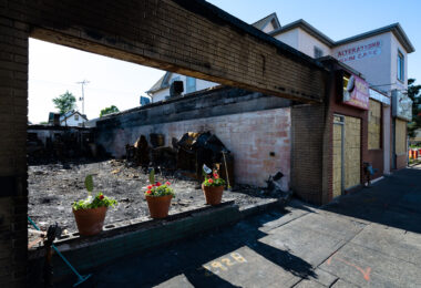 Flowers in the windows of a burned out restaurant on Chicago Ave.