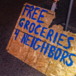 A sign on the streets of Minneapolis offering groceries to neighbors.