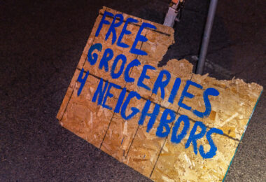 A sign on the streets of Minneapolis offering groceries to neighbors.