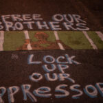 "Free our brothers. Lock up our oppressors" writer on Chicago Ave.