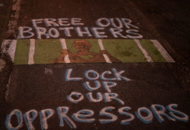 "Free our brothers. Lock up our oppressors" writer on Chicago Ave.