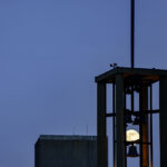 A full moon rising behind church bells in Downtown Minneapolis.
